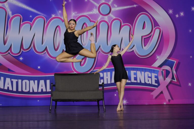 Born Dance Academy dancer mid-leap in competition